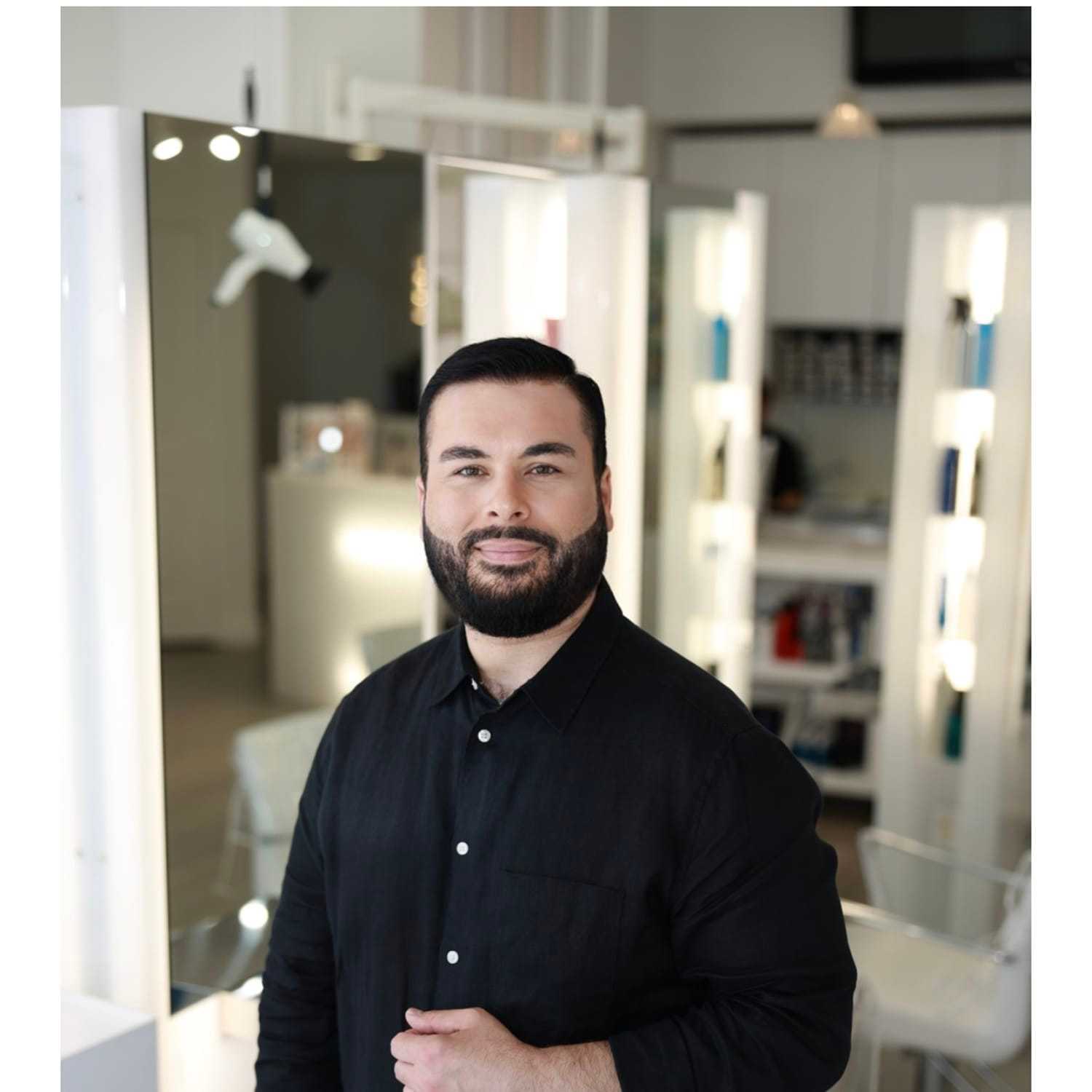 Portrait of Hussein Sal, a professional stylist at Athena Medspa and Salon, showcasing their expertise and style.