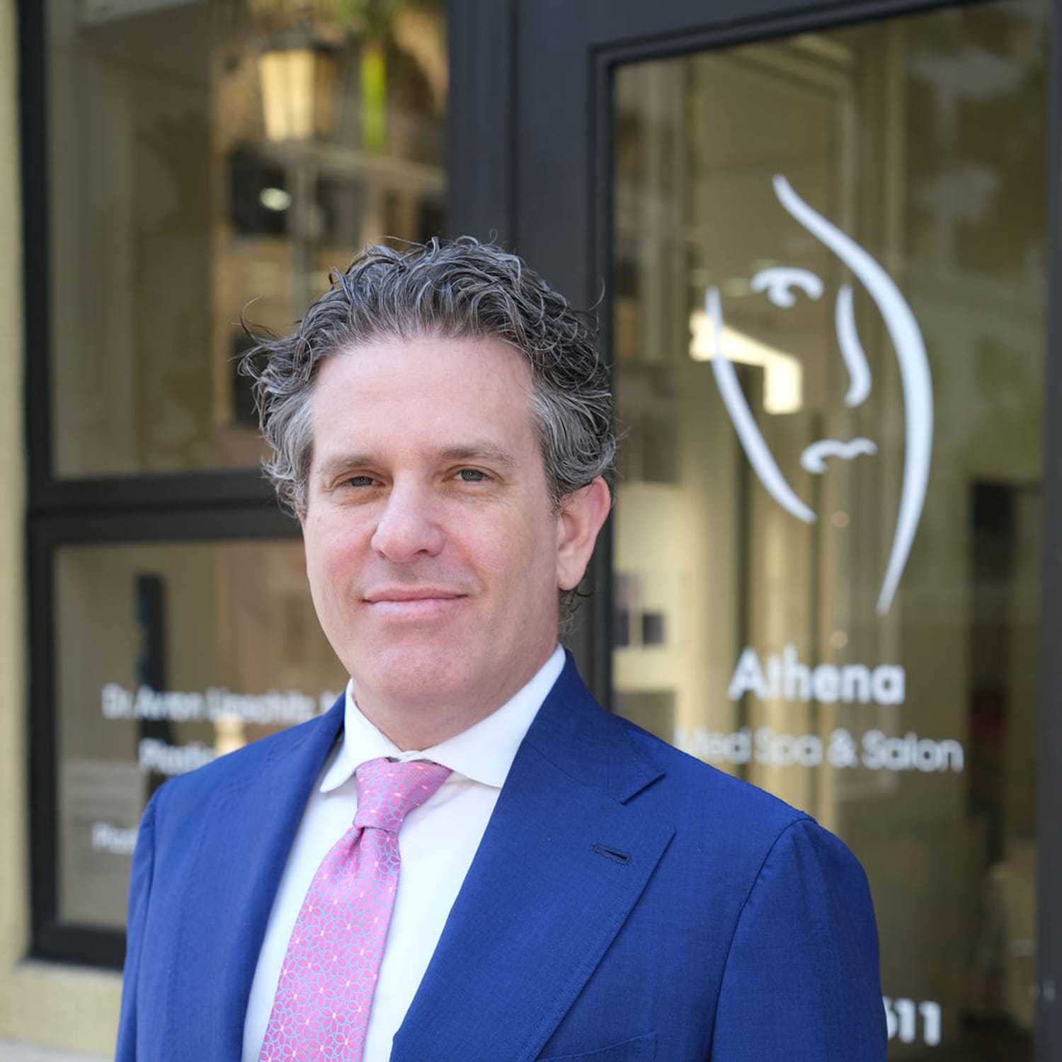 Portrait of Dr. Avron Lipschitz, a professional stylist at Athena Medspa and Salon, showcasing their expertise and style.