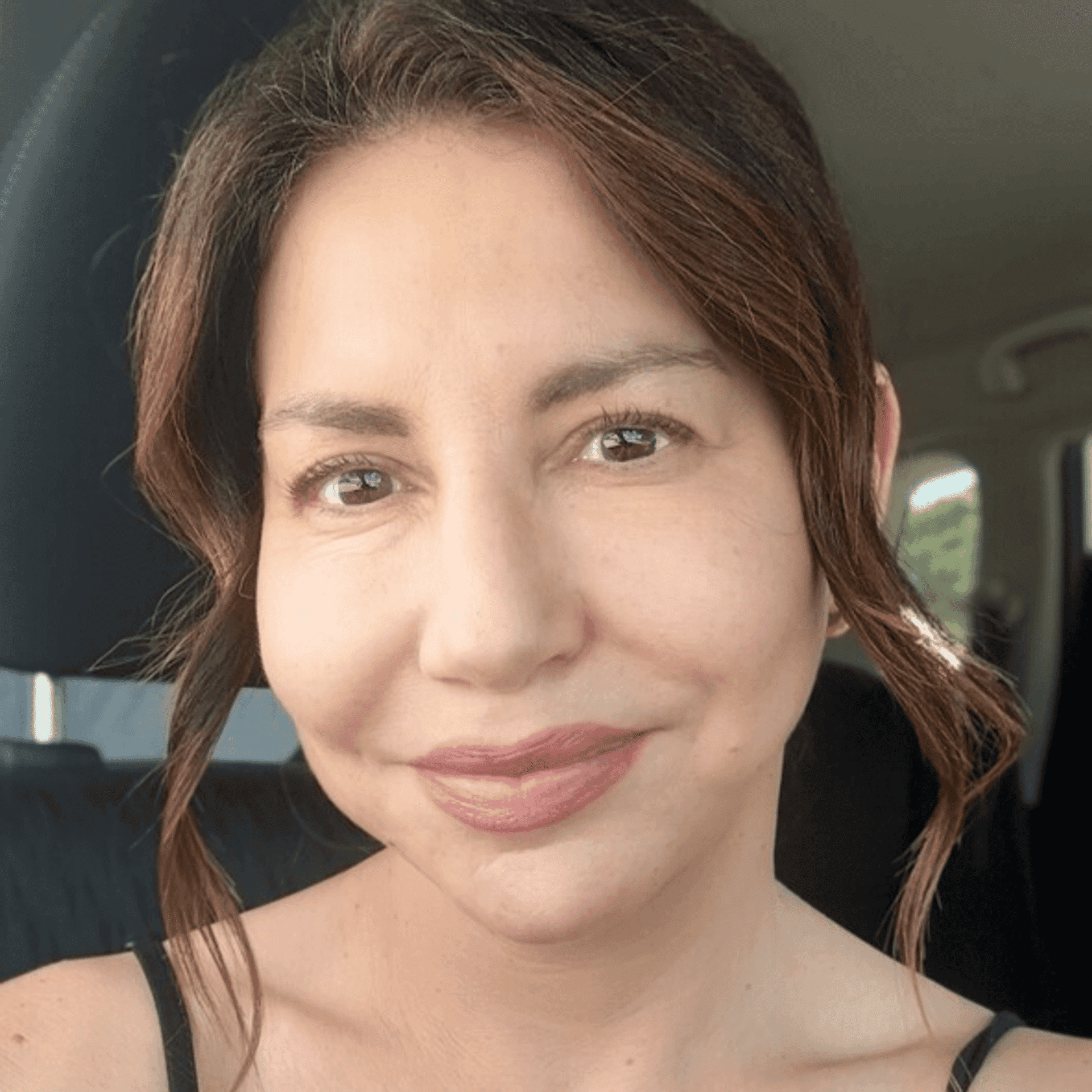 Portrait of Polina Yesilevich, a professional stylist at Athena Medspa and Salon, showcasing their expertise and style.