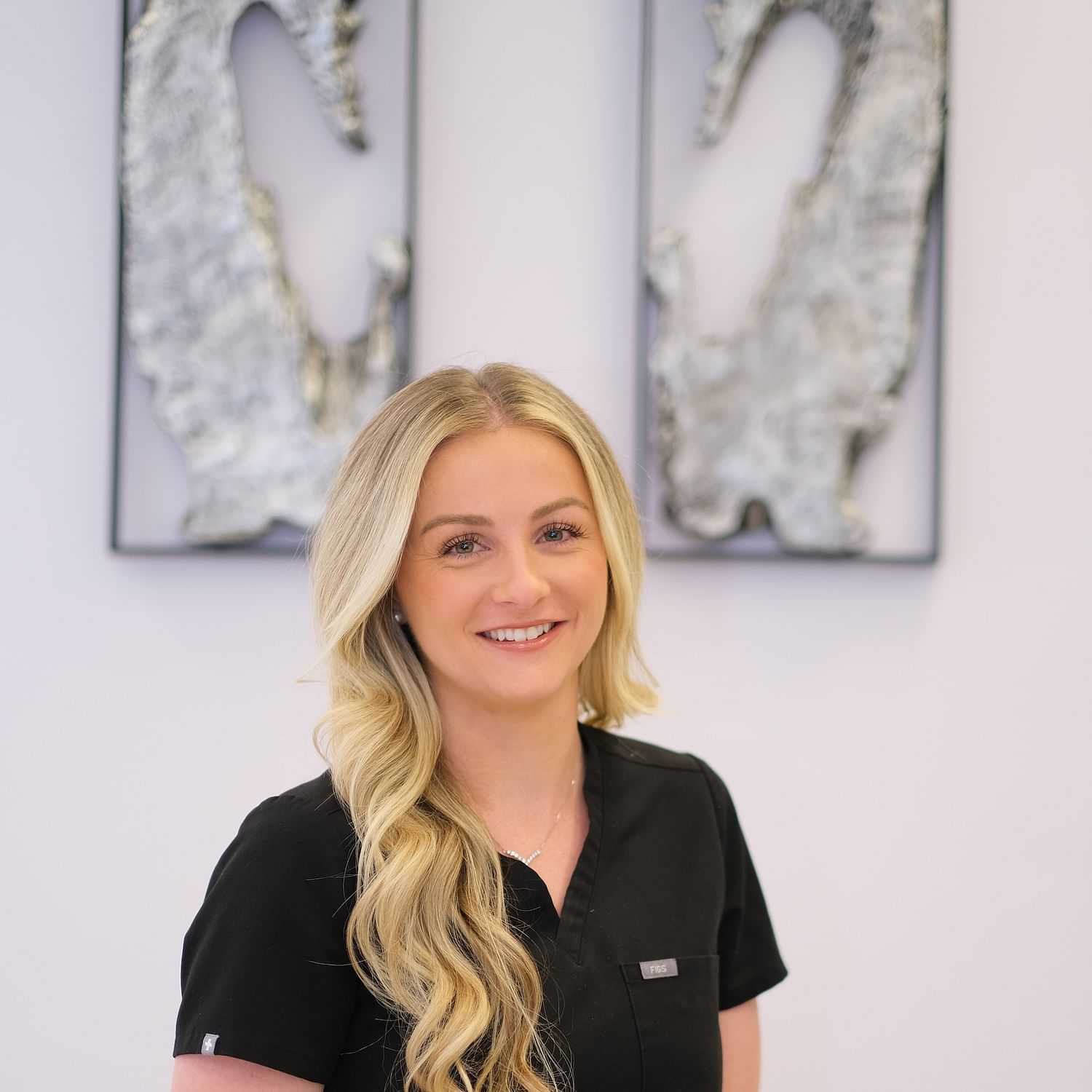 Portrait of Kylie Brandt, a professional stylist at Athena Medspa and Salon, showcasing their expertise and style.