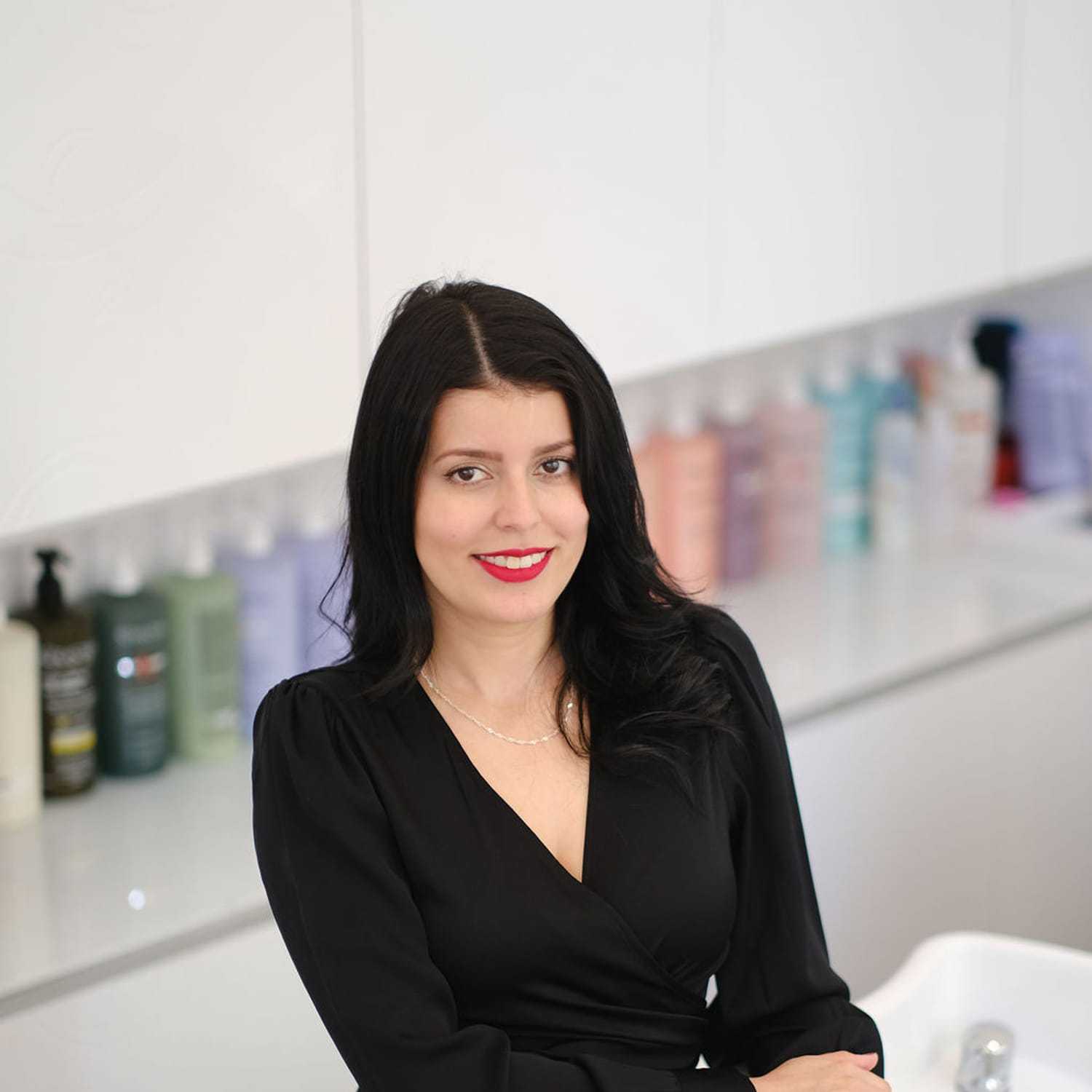 Portrait of Laura Arredondo, a professional stylist at Athena Medspa and Salon, showcasing their expertise and style.