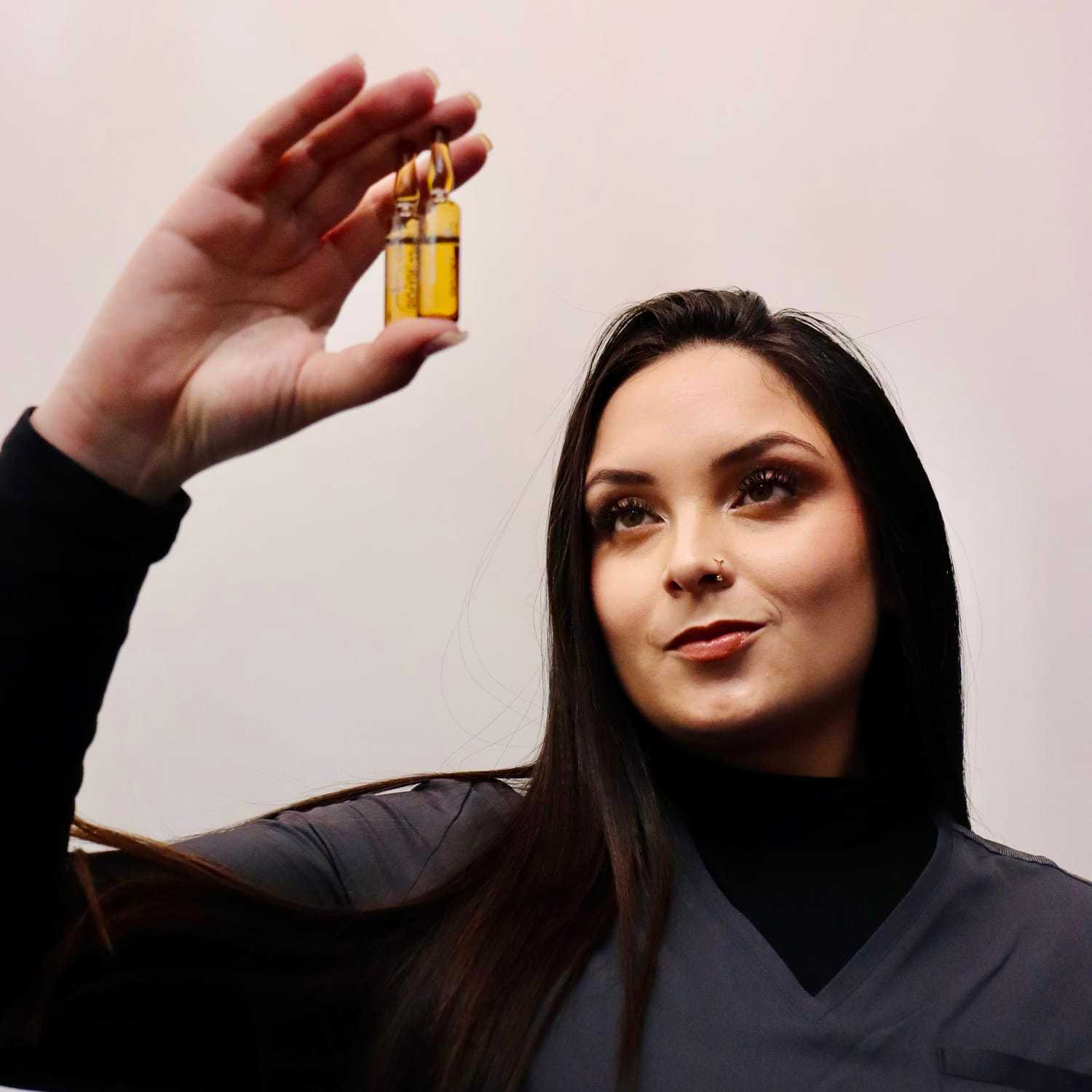 Portrait of Michelle, a professional stylist at Athena Medspa and Salon, showcasing their expertise and style.