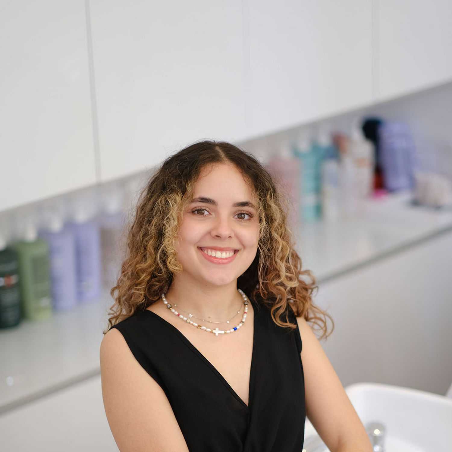 Portrait of Maria Infante, a professional stylist at Athena Medspa and Salon, showcasing their expertise and style.