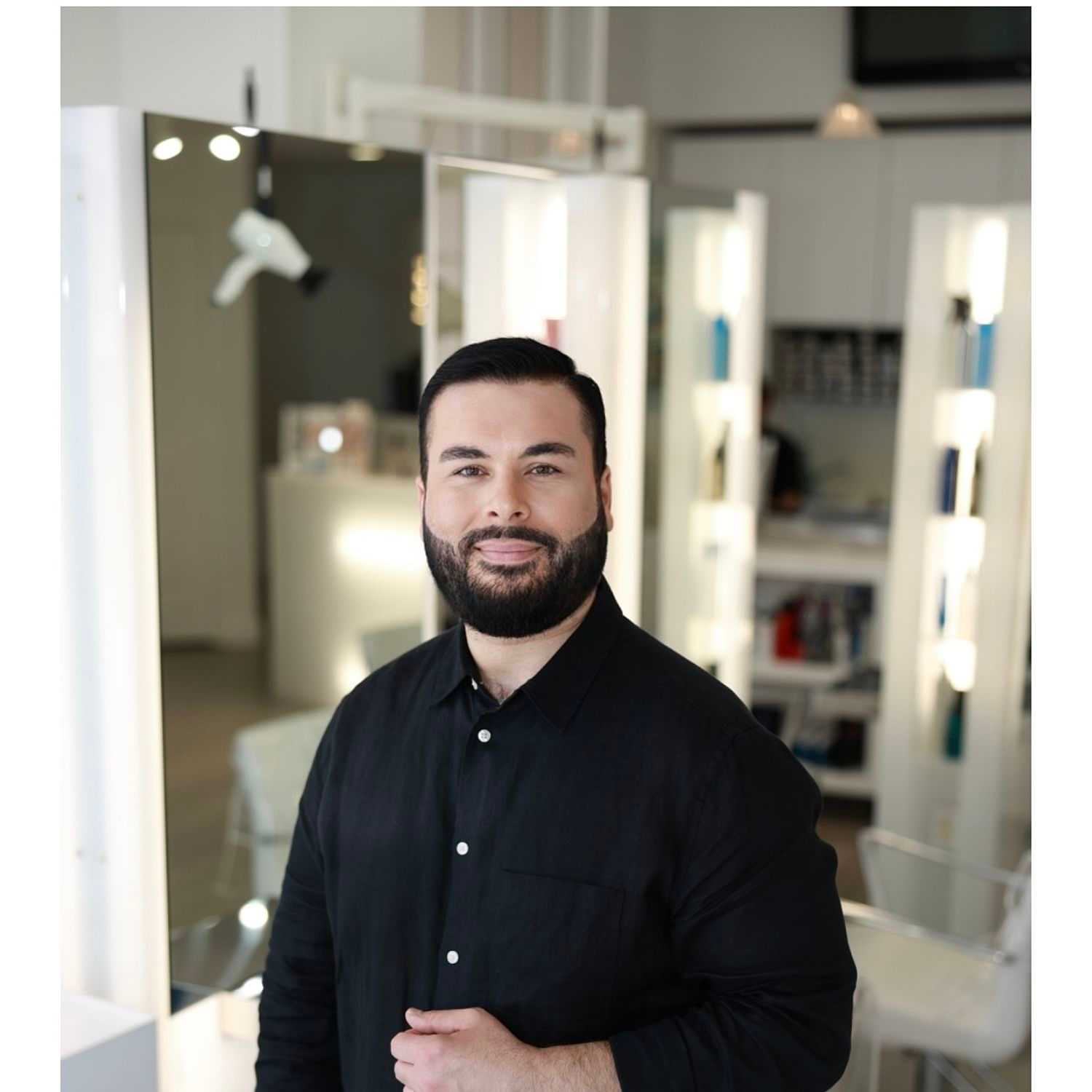 Portrait of Hussein Sal, a professional stylist at Athena Medspa and Salon, showcasing their expertise and style.